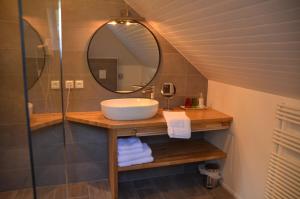 a bathroom with a sink and a mirror at Domaine Utah Beach - Le Grand Hard in Sainte-Marie-du-Mont