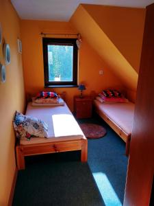 a small room with two beds and a window at Tomaszówka in Płaska +3 photos