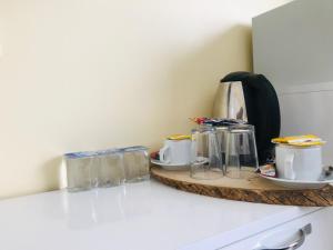 a kitchen counter with a shelf with tea pots and pans at La Mer Boutique Hotel & Guesthouse in Istanbul