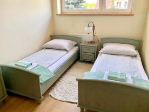 Posteľ alebo postele v izbe v ubytovaní Willa Łąkowa
