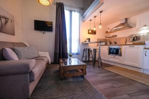 a living room with a couch and a table at Demeure Terrisse La Maison in Marseillan