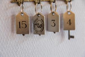 a bunch of tags hanging on a wall at Domaine Utah Beach - Le Grand Hard in Sainte-Marie-du-Mont
