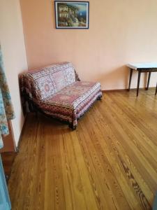 a couch in a room with a wooden floor at FRONTE PO in Turin
