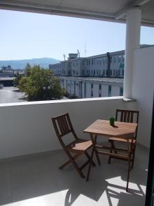 two chairs and a table on a balcony at Rooms Vodisek - Depandansa Hotela Capris Capodistria Boutique in Koper
