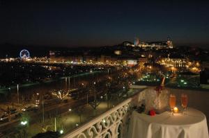 a view of a city at night from a balcony at Hotel Splendid in Cannes