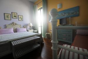 a bedroom with a bed and a dresser at IL NIDO AL LAGO in Gavirate