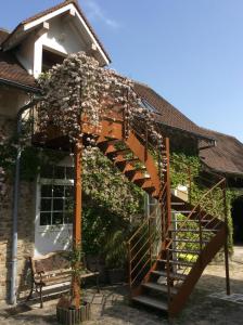 a wooden spiral staircase in front of a house at L’Orme des voyageurs in Boutigny