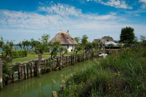 a bridge over a river next to a house at Ducale in Bibione