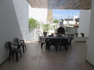 a dining room with a table and chairs on a balcony at Maison Gigante in San Donato di Lecce