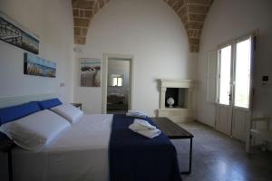 a bedroom with a large bed and a fireplace at VILLA ROSA in Torre Suda