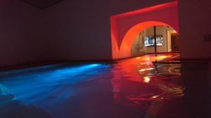 uma piscina de água com luzes vermelhas e azuis em Hotel Centrale em Siracusa