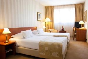 Posteľ alebo postele v izbe v ubytovaní Hotel Globo
