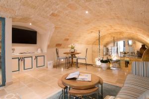 a living room with a table and chairs and a kitchen at Hotel Don Ferrante in Monopoli