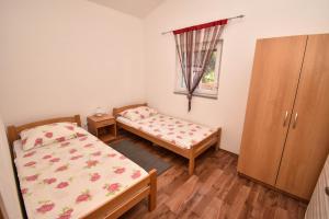Ein Bett oder Betten in einem Zimmer der Unterkunft Apartmani Lukic