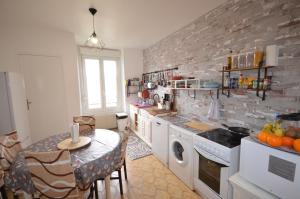 a kitchen with a counter and a table with a sink at 23 Rue de la République in Gérardmer