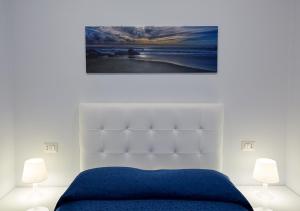 a bedroom with a blue bed and two lamps at Residenza Duomo in Avezzano