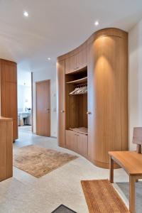 a living room with wooden cabinets and a table at Chesa Chalavus - St. Moritz in St. Moritz