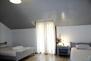 Posteľ alebo postele v izbe v ubytovaní Hotel Akropolis