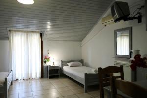 Posteľ alebo postele v izbe v ubytovaní Hotel Akropolis