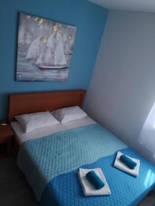a bedroom with a bed with two towels on it at Apartment Vesna in Novalja