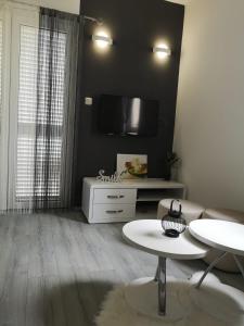 a living room with a couch and a flat screen tv at Apartment Vesna in Novalja