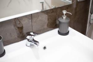 a bathroom sink with a faucet on a counter at Privilege Chiaia by Dimorra in Naples