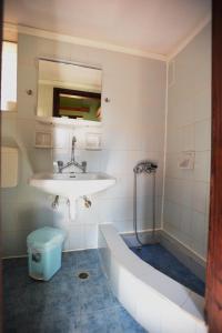 a bathroom with a sink and a bath tub at Stelios Rooms to Rent in Chania Town