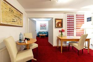 a living room with a table and chairs at Bucur Accommodation in Bucharest