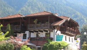 a large wooden building with balconies on a mountain at Appartement-Azalea in Oetz