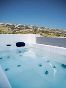 a jacuzzi tub with a view of a desert at Valery Suites in Fira