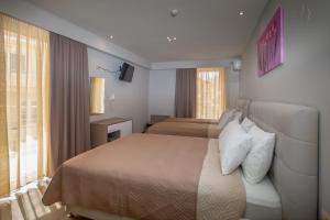 Posteľ alebo postele v izbe v ubytovaní Irini Hotel