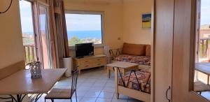 a small living room with a couch and a tv at mare natura confort... il mio paradiso in Sardegna in Isola Rossa +6 photos