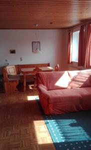 a living room with a couch and a table at Ferienhof Jungkunz in Schwarzenbach am Wald