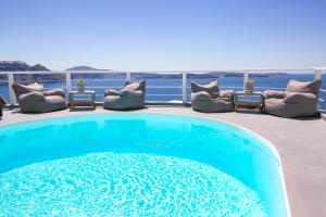a swimming pool on the deck of a house at White Pearl Villas in Oia