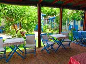a patio with a table and chairs and a table at Amazon Antique in Selçuk