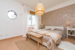 a bedroom with a large bed and a large window at Quinta da Gomeira by Algartur in Cabanas de Tavira +30 photos