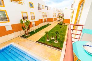 a view of the pool from the balcony of a apartment at Quinta da Gomeira by Algartur in Cabanas de Tavira