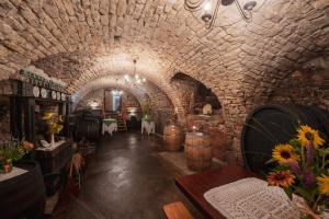 a wine cellar with barrels and flowers in a tunnel at Laubgassl in Mörbisch am See