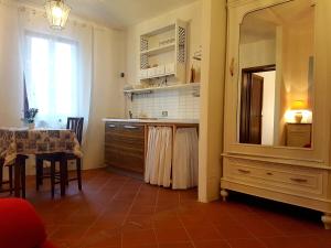 a kitchen with a dresser and a table with a mirror at Il Villino in Lucca
