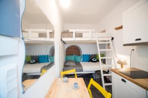 a small room with two bunk beds and a table at Cute Mykonos DownTown Studio in Mýkonos City