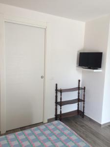 A television and/or entertainment centre at DEPENDANCE LAZISE LAGO DI GARDA
