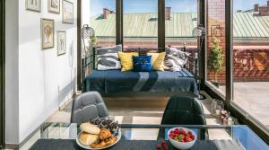 a balcony with a bed and a bowl of food at 7 Koron - Exclusive Apartments in Krakow