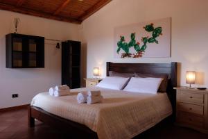 a bedroom with a large bed with towels on it at Terra di Mezzo in Collepasso