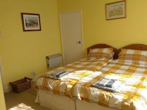 a bedroom with a bed with a checkered blanket at Heavenly Outlook in Scarborough