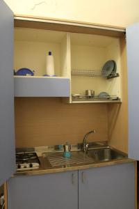 a kitchen with a sink and a counter top at Stanzetta del Cavaliere in Atrani