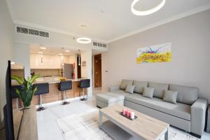 a living room with a couch and a table at KeyHost - Regent Court JVC - K390 in Dubai