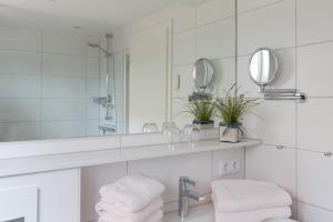 a bathroom with a sink and a mirror at Strandhaus Christiansen in Cuxhaven +148 photos