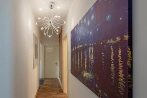 a hallway with a large painting on the wall at Villa Alberta in Tenna 