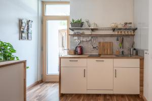 a kitchen with white cabinets and a sink at Villa Alberta in Tenna 