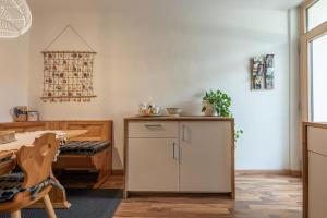 a kitchen with a counter and a table and a chair at Villa Alberta in Tenna 